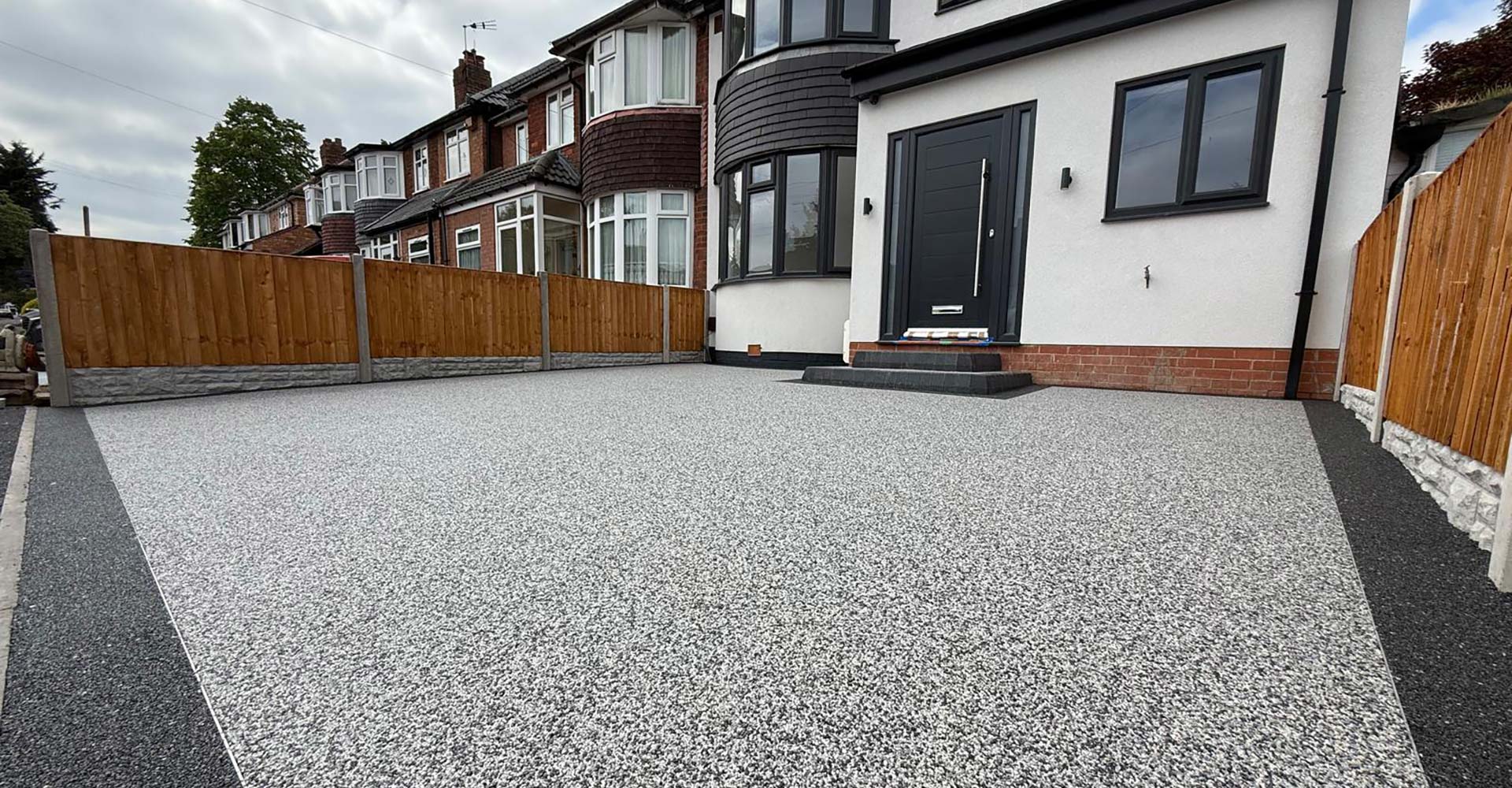 Completed silver-grey resin driveway across a modernised house frontage