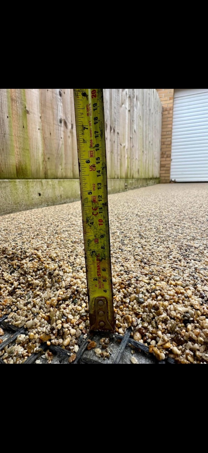 A JD Resin Solutions depth check during a warm-toned resin surface installation