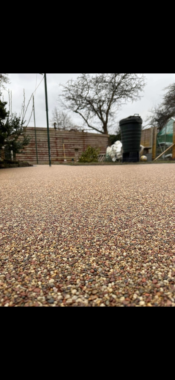 A close view of a completed warm-toned resin pathway surface